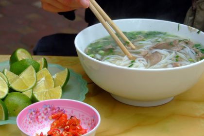 A steaming bowl of beef pho with herbs, the kind served at the best pho in Montreal spots