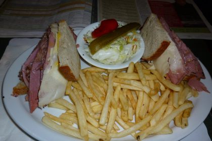 Montreal-style smoked meat sandwich on rye with fries, a taste of the best smoked meat in Montreal