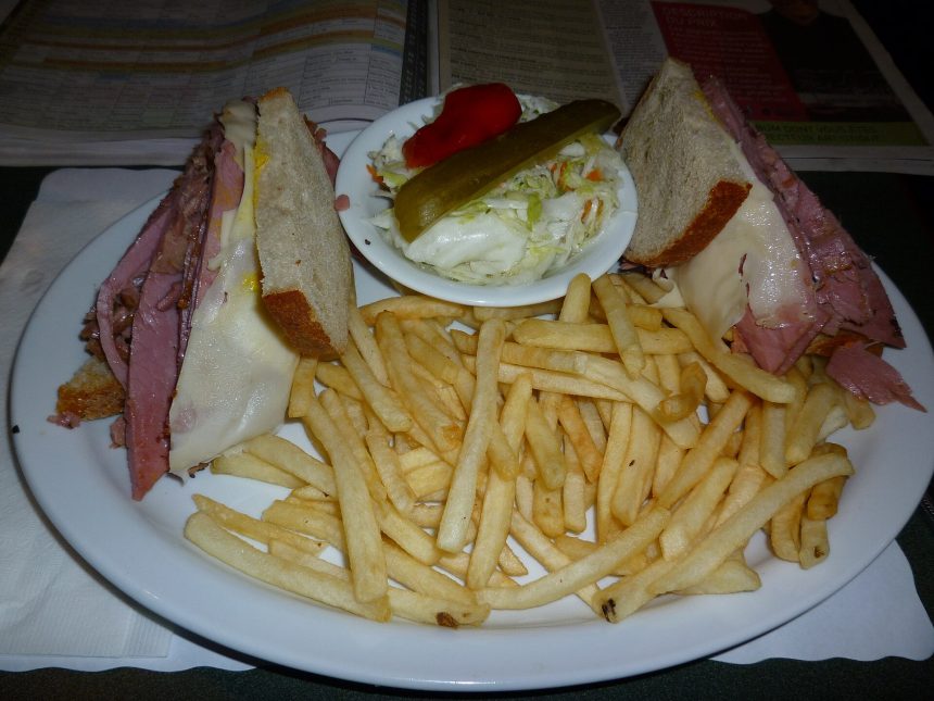 Montreal-style smoked meat sandwich on rye with fries, a taste of the best smoked meat in Montreal