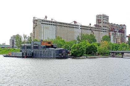 Bota Bota floating spa boat moored in Montreal's Old Port, a Nordic spa in Montreal, with grain elevators behind