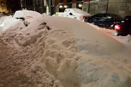 Car buried in snow on a Montreal street after a blizzard, a reminder of why winter tires in Quebec are mandatory from Dec. 1